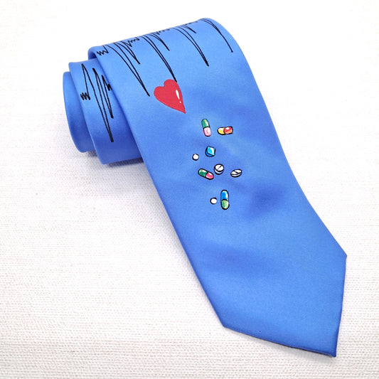 A royal blue silk necktie that is hand painted with medical doctors symbols and images including a stethoscope, heart rate readings and tablets or pills